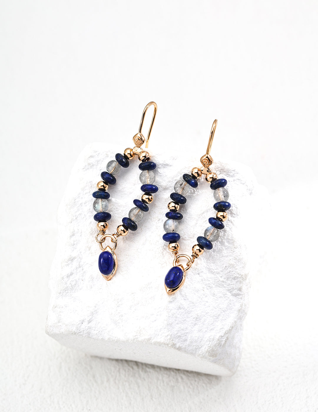 These handcrafted S925 silver earrings feature a stunning combination of deep blue lapis lazuli and luminous moonstone. The contrast between the rich lapis and the soft glow of moonstone makes these earrings a timeless, elegant choice for both everyday wear and special occasions.