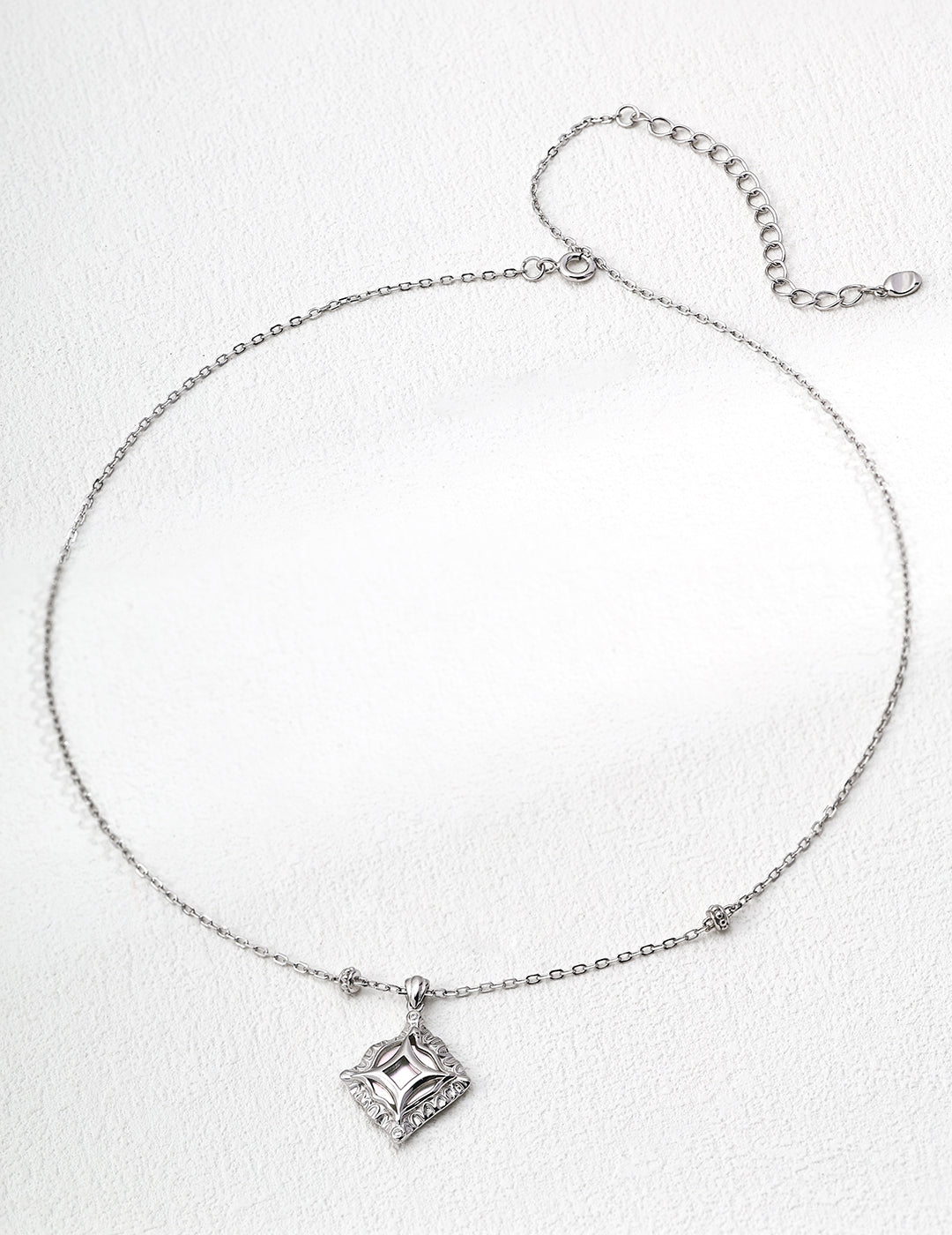 This handcrafted S925 silver necklace features a radiant mother of pearl centerpiece, accented with sparkling zircon stones. Its minimalist yet refined design makes it ideal for adding a subtle touch of elegance to both everyday and formal outfits.
