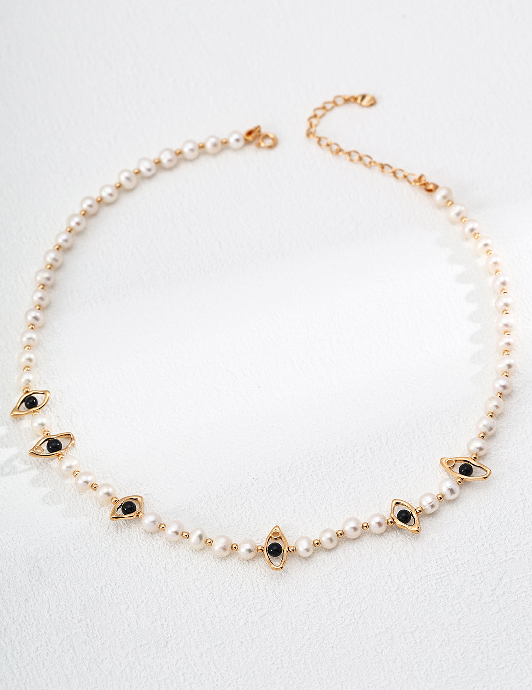 This handcrafted necklace combines the classic beauty of pearls with the bold contrast of black onyx beads, all set on S925 silver. Its elegant black-and-white palette makes it a timeless piece perfect for both everyday wear and formal occasions.