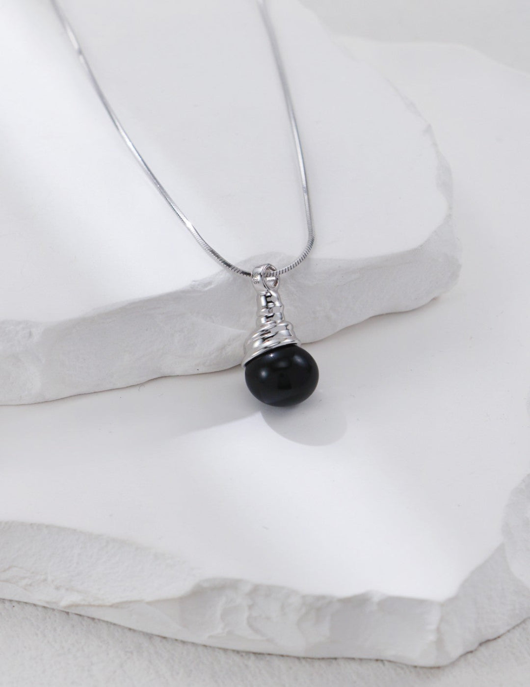 This handcrafted S925 silver pendant necklace features a bold black onyx stone in a sleek, minimalist design. Perfect for everyday wear or layered styling, it adds a touch of modern elegance and grounding energy to any outfit.