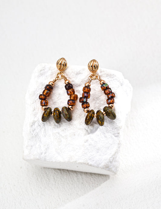 These S925 silver drop earrings feature shimmering iridescent glass beads in a vintage-inspired design. Their soft glow and retro elegance make them a perfect accessory for adding a touch of timeless beauty to any outfit. Ideal for lovers of nostalgic, handcrafted jewelry with a modern twist.