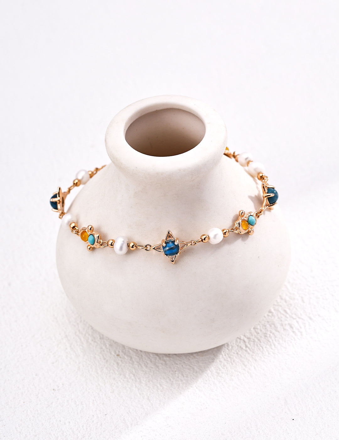 This S925 silver retro bracelet features a stunning combination of natural pearls, turquoise, and chalcedony, creating a vintage-inspired design with vibrant colors. The intricate blend of gemstones adds a unique and elegant touch to this bracelet, perfect for both casual and formal occasions. Ideal for those who appreciate high-quality, handcrafted jewelry with a timeless, nature-inspired appeal.