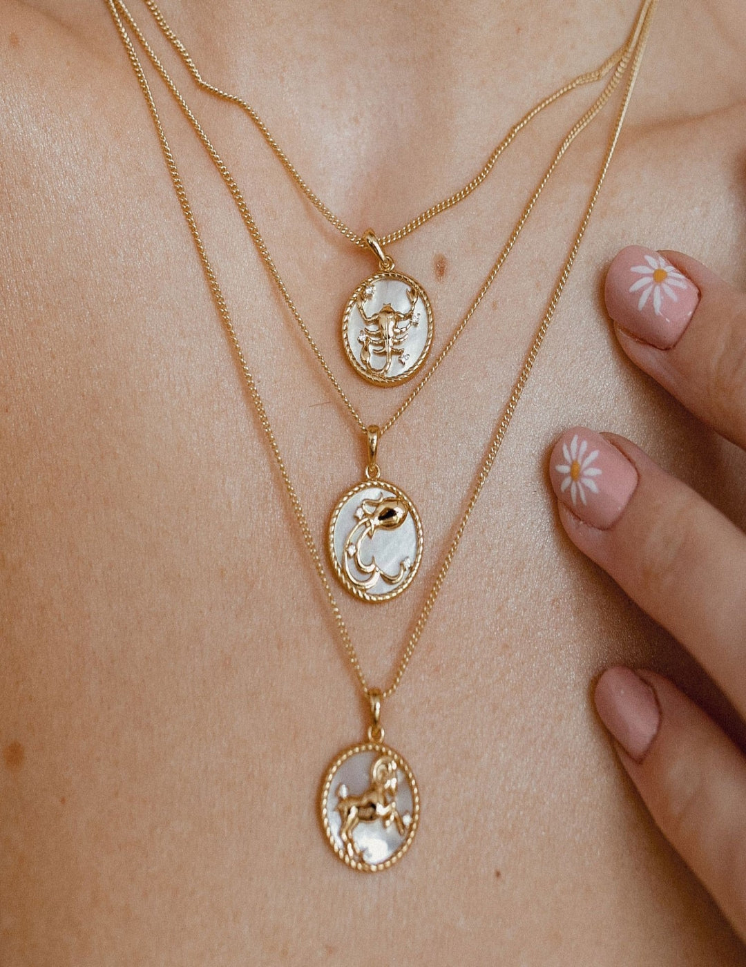 Three zodiac pearl necklaces displayed side by side, each featuring a unique constellation pendant with real freshwater pearls – Sagittarius, Taurus, and Pisces designs shown. A perfect personalized astrology jewelry gift for her.