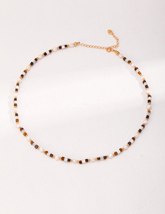 Elegant pendant necklace featuring natural tiger eye and mother of pearl gemstones, set in a vintage-style design — symbolizing inner strength, clarity, and emotional harmony, perfect for spiritual jewelry lovers and boho chic fashion