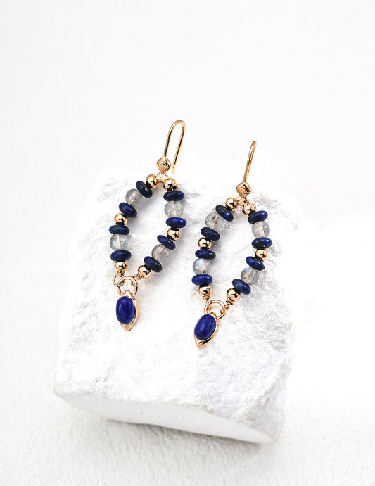 These handcrafted S925 silver earrings feature a stunning combination of deep blue lapis lazuli and luminous moonstone. The contrast between the rich lapis and the soft glow of moonstone makes these earrings a timeless, elegant choice for both everyday wear and special occasions.