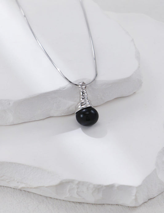 This handcrafted S925 silver pendant necklace features a bold black onyx stone in a sleek, minimalist design. Perfect for everyday wear or layered styling, it adds a touch of modern elegance and grounding energy to any outfit.